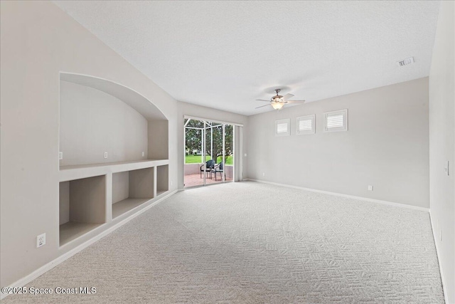 4160 Aberdeen Cir, Rockledge, FL 32955 - carpeted spare room with a ceiling fan, a textured ceiling, and built in shelves