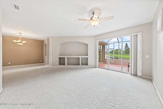 4160 Aberdeen Cir, Rockledge, FL 32955 - unfurnished living room featuring a chandelier, carpet floors, built in features, a ceiling fan, and a textured ceiling