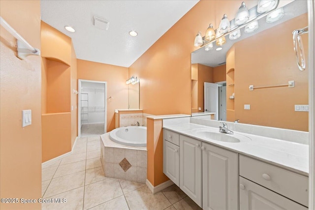4160 Aberdeen Cir, Rockledge, FL 32955 - full bathroom featuring vanity, tile patterned floors, a garden tub, and a spacious closet
