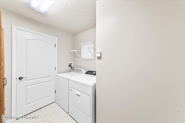 4160 Aberdeen Cir, Rockledge, FL 32955 - laundry room with washer and dryer, light tile patterned flooring, and a textured ceiling