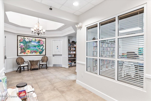 4160 Aberdeen Cir, Rockledge, FL 32955 - sitting room with a chandelier, light tile patterned floors, a tray ceiling, and crown molding