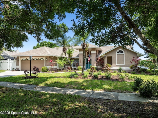 3360 Fort Sumter St, Melbourne, FL 32934 - ranch-style house featuring stucco siding, a garage, a front lawn, and concrete driveway