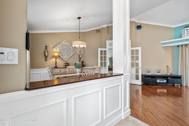 3360 Fort Sumter St, Melbourne, FL 32934 - kitchen with ornamental molding, wood finished floors, butcher block counters, pendant lighting, and ornate columns