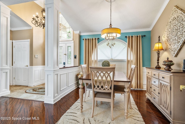 3360 Fort Sumter St, Melbourne, FL 32934 - dining room with a chandelier, a wainscoted wall, dark wood-style floors, a decorative wall, and crown molding