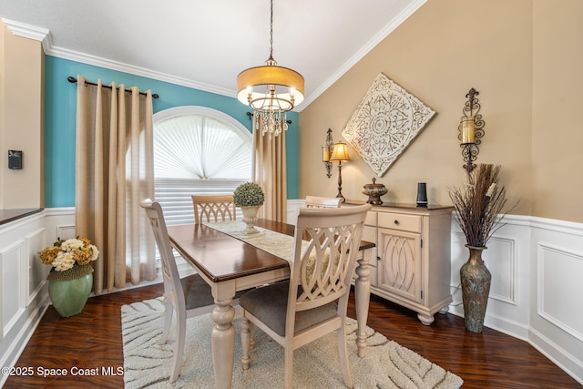 3360 Fort Sumter St, Melbourne, FL 32934 - dining area with a chandelier, a decorative wall, dark wood-style floors, crown molding, and wainscoting