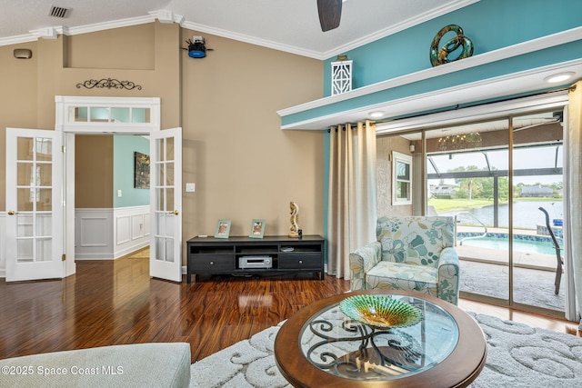 3360 Fort Sumter St, Melbourne, FL 32934 - living area featuring french doors, wood finished floors, ornamental molding, lofted ceiling, and a ceiling fan