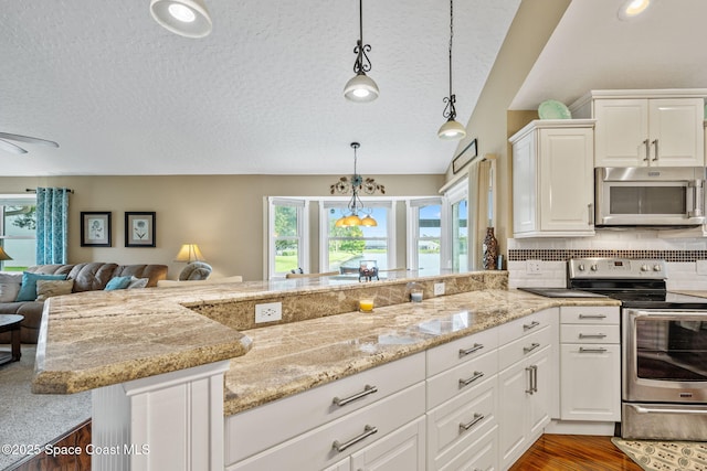3360 Fort Sumter St, Melbourne, FL 32934 - kitchen with stainless steel appliances, a textured ceiling, light stone countertops, hanging light fixtures, and backsplash