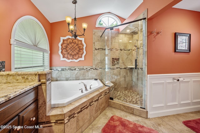 3360 Fort Sumter St, Melbourne, FL 32934 - full bath with a garden tub, vaulted ceiling, a shower stall, vanity, and a wainscoted wall