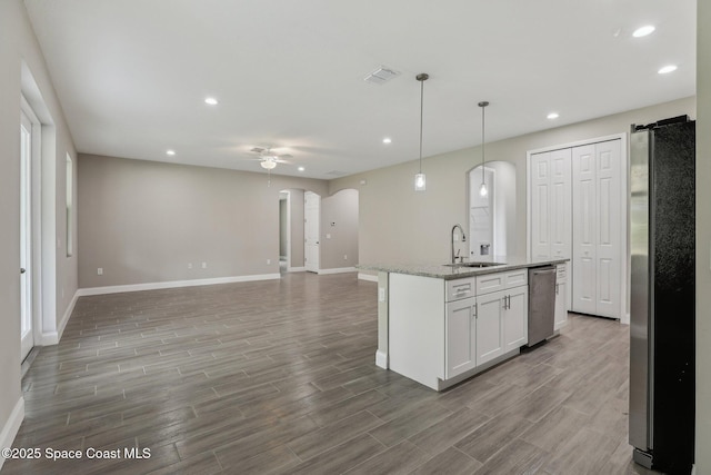 1342 Tordira St SE, Palm Bay, FL 32909 - kitchen with appliances with stainless steel finishes, a sink, arched walkways, ceiling fan, and baseboards