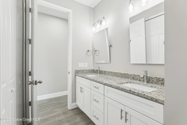 1342 Tordira St SE, Palm Bay, FL 32909 - full bathroom featuring double vanity, baseboards, and wood finished floors