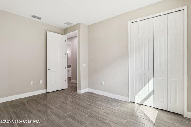 1342 Tordira St SE, Palm Bay, FL 32909 - unfurnished bedroom featuring wood finish floors, baseboards, and a closet