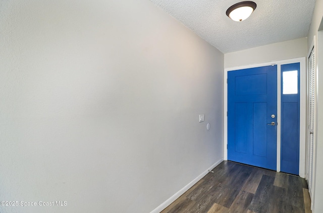 1573 Eagle Ave NW, Palm Bay, FL 32907 - foyer featuring a textured ceiling, baseboards, and dark wood-type flooring