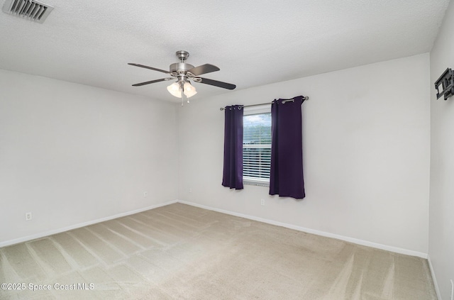 1573 Eagle Ave NW, Palm Bay, FL 32907 - spare room with ceiling fan, light colored carpet, baseboards, and a textured ceiling