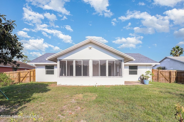 1573 Eagle Ave NW, Palm Bay, FL 32907 - back of house with a sunroom, stucco siding, and a gate