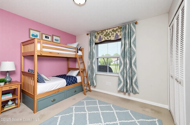 1573 Eagle Ave NW, Palm Bay, FL 32907 - bedroom with a closet, carpet, baseboards, and a textured ceiling