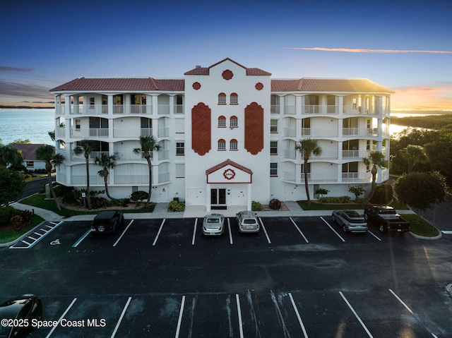 8984 Puerto Del Rio Dr Unit 202, Cape Canaveral, FL 32920 - view of building exterior with uncovered parking