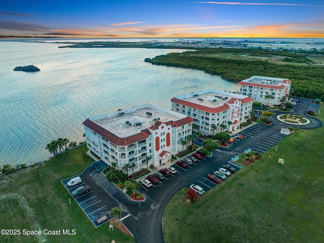 8984 Puerto Del Rio Dr Unit 202, Cape Canaveral, FL 32920 - aerial view at dusk of a water view and a view of apartment building / complex