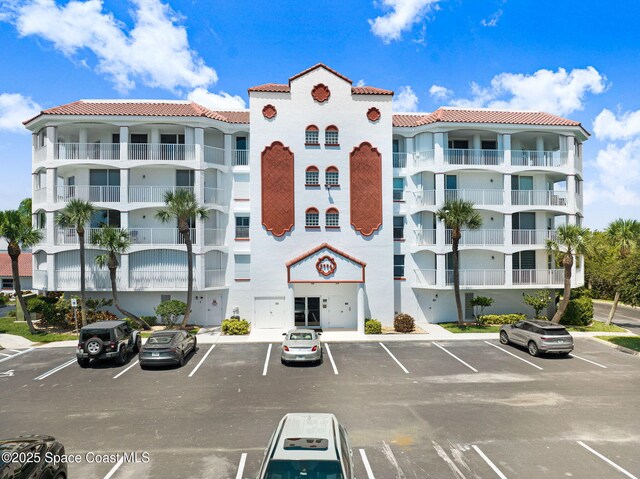 8984 Puerto Del Rio Dr Unit 202, Cape Canaveral, FL 32920 - view of apartment building / complex featuring uncovered parking