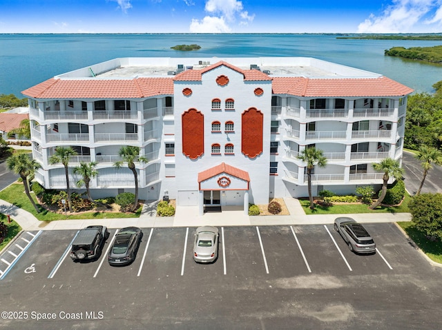 8984 Puerto Del Rio Dr Unit 202, Cape Canaveral, FL 32920 - view of apartment building / complex with uncovered parking and a water view