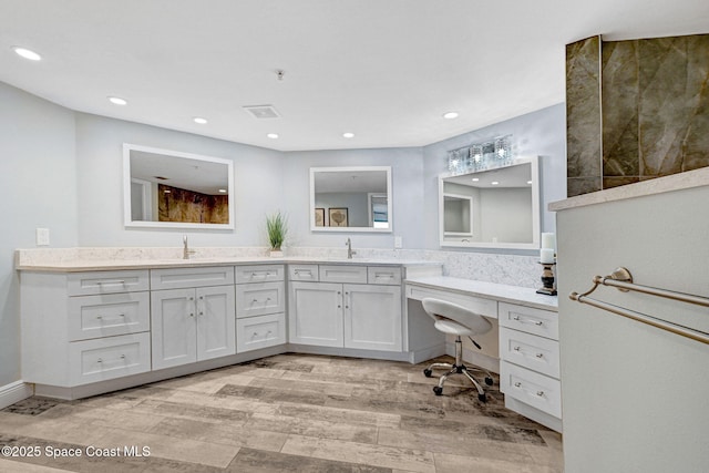 8984 Puerto Del Rio Dr Unit 202, Cape Canaveral, FL 32920 - full bathroom featuring wood finished floors, double vanity, and recessed lighting