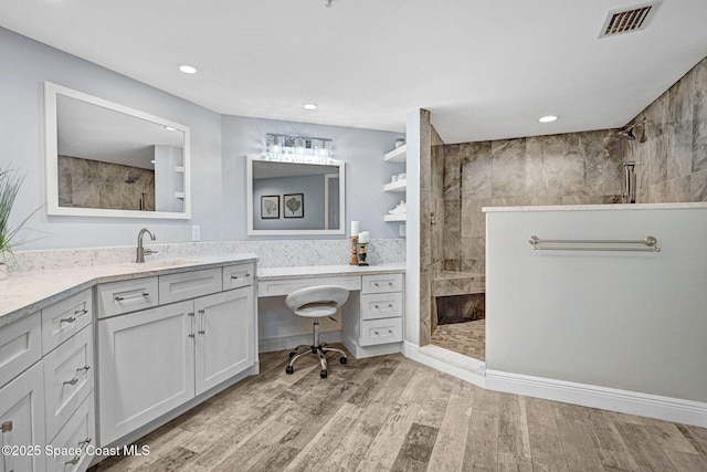 8984 Puerto Del Rio Dr Unit 202, Cape Canaveral, FL 32920 - full bath featuring walk in shower, vanity, wood finished floors, and recessed lighting