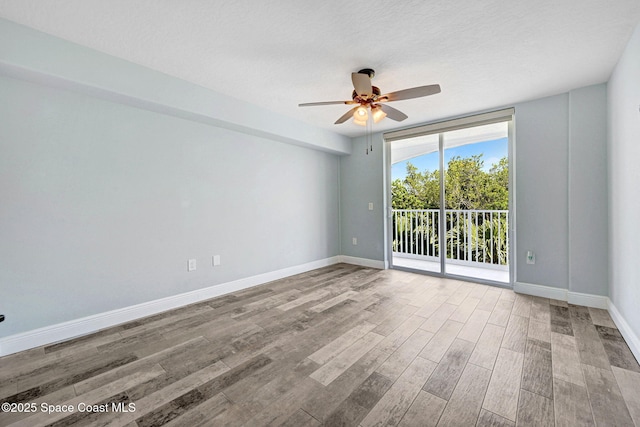 8984 Puerto Del Rio Dr Unit 202, Cape Canaveral, FL 32920 - spare room featuring a ceiling fan, wood finished floors, and baseboards