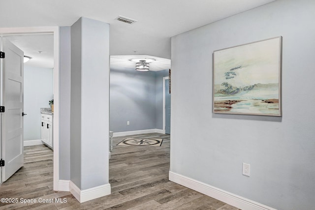 8984 Puerto Del Rio Dr Unit 202, Cape Canaveral, FL 32920 - hall featuring baseboards and light wood-style flooring