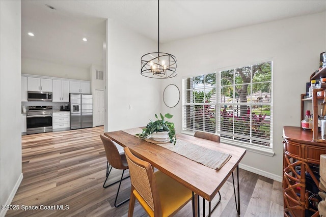 3046 Sebastian Ln, Melbourne, FL 32935 - dining space with light wood-style floors, a chandelier, and baseboards