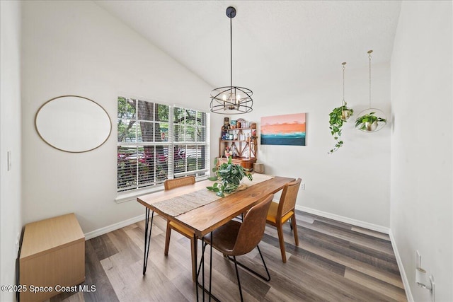 3046 Sebastian Ln, Melbourne, FL 32935 - dining room featuring wood finished floors, baseboards, a chandelier, and high vaulted ceiling