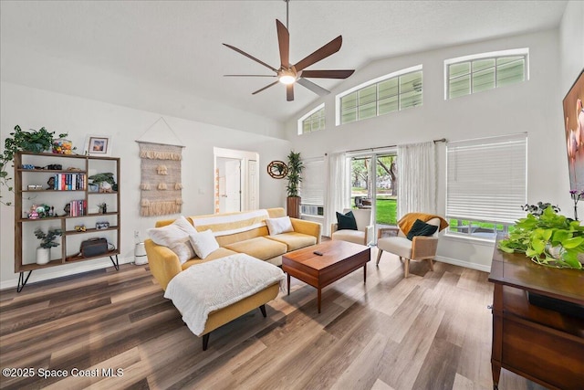 3046 Sebastian Ln, Melbourne, FL 32935 - living area featuring a ceiling fan, wood finished floors, high vaulted ceiling, and baseboards