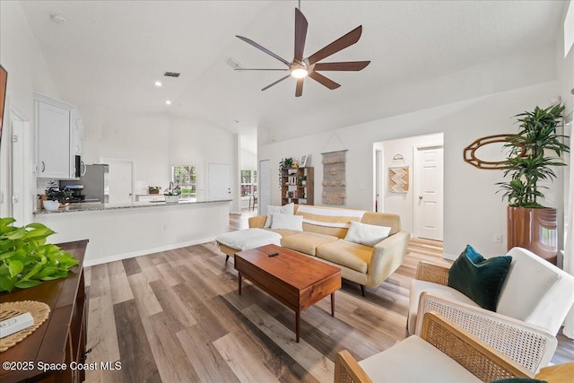 3046 Sebastian Ln, Melbourne, FL 32935 - living area with ceiling fan, light wood-style floors, recessed lighting, and high vaulted ceiling