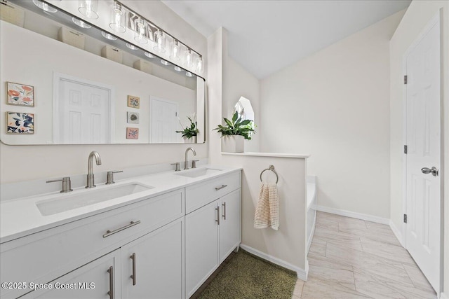 3046 Sebastian Ln, Melbourne, FL 32935 - full bathroom with baseboards, double vanity, marble finish floors, and a bath