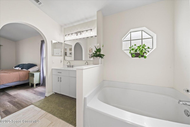 3046 Sebastian Ln, Melbourne, FL 32935 - bathroom featuring vanity, a garden tub, and ensuite bath
