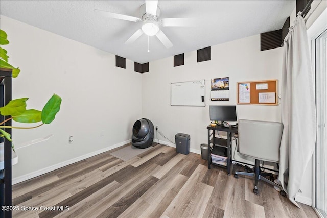 3046 Sebastian Ln, Melbourne, FL 32935 - home office with wood finished floors, ceiling fan, baseboards, and a textured ceiling