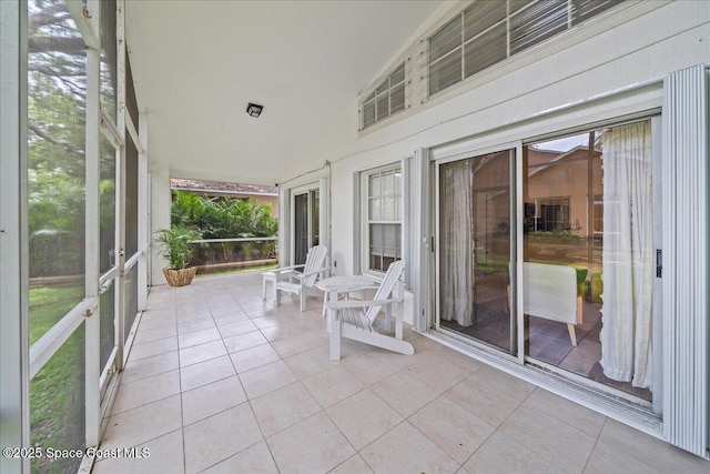 3046 Sebastian Ln, Melbourne, FL 32935 - unfurnished sunroom featuring tile patterned floors and high vaulted ceiling