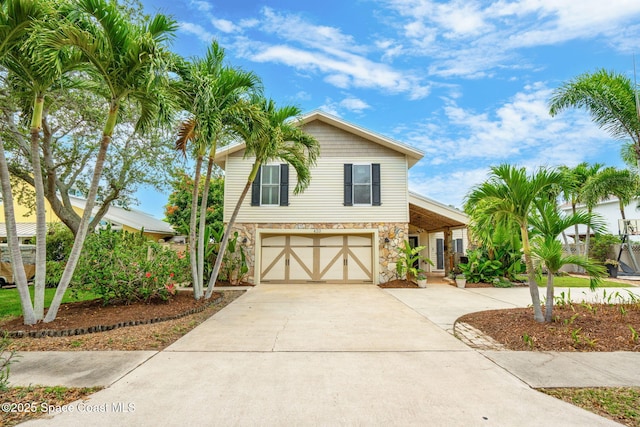 420 Tortoise View Cir, Satellite Beach, FL 32937 - view of front of house with stone siding, driveway, and an attached garage
