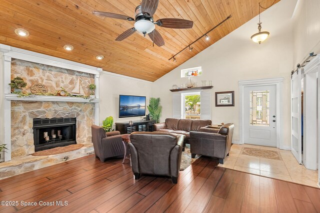 420 Tortoise View Cir, Satellite Beach, FL 32937 - living area with wooden ceiling, high vaulted ceiling, hardwood / wood-style floors, ceiling fan, and a stone fireplace