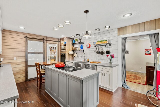 420 Tortoise View Cir, Satellite Beach, FL 32937 - kitchen with a sink, stainless steel appliances, a center island, dark wood-style floors, and light countertops