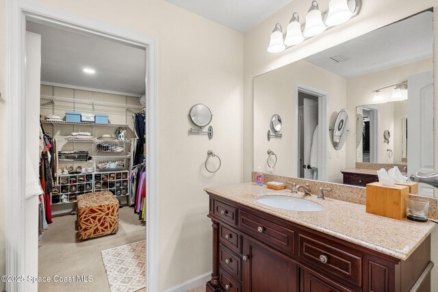 420 Tortoise View Cir, Satellite Beach, FL 32937 - bathroom featuring vanity and a walk in closet
