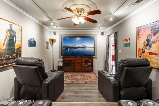 420 Tortoise View Cir, Satellite Beach, FL 32937 - home theater with rail lighting, wood finished floors, ornamental molding, and ceiling fan