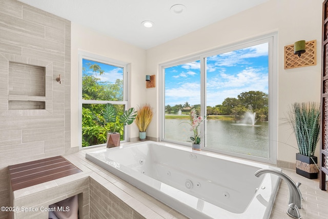 420 Tortoise View Cir, Satellite Beach, FL 32937 - full bathroom featuring a tub with jets, healthy amount of natural light, a water view, and recessed lighting