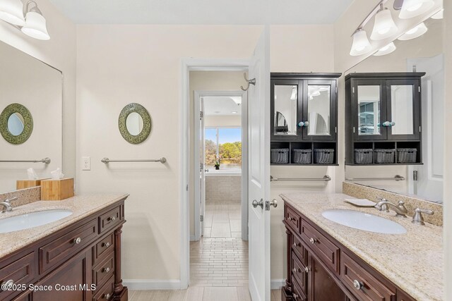 420 Tortoise View Cir, Satellite Beach, FL 32937 - bathroom featuring two vanities, tile patterned flooring, and baseboards