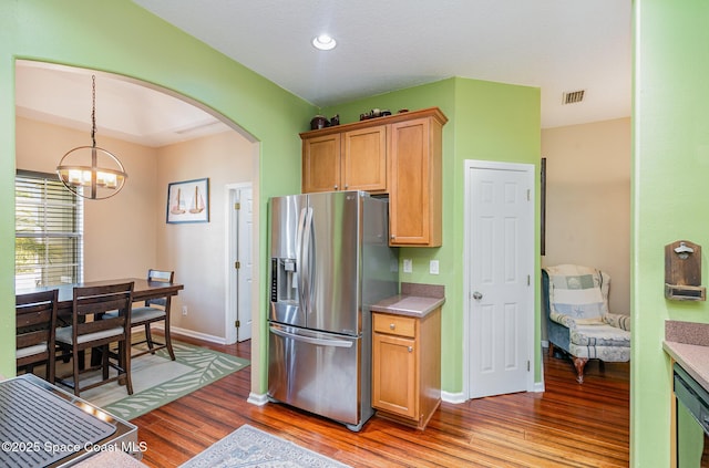 2871 Fontainebleau Ave SE, Palm Bay, FL 32909 - kitchen featuring stainless steel fridge, arched walkways, light wood-style flooring, a chandelier, and baseboards