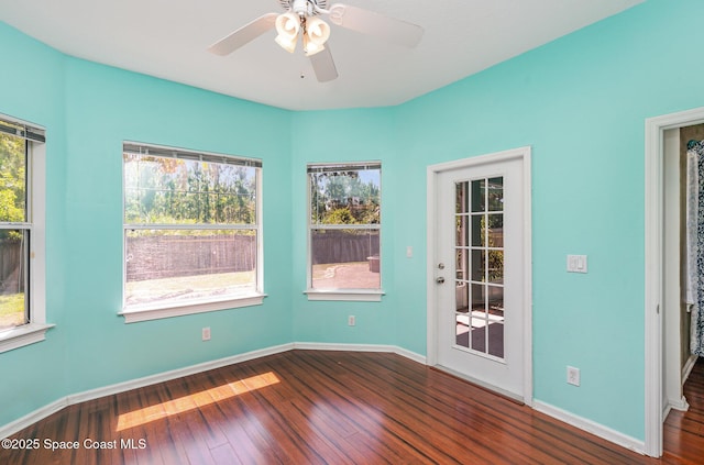 2871 Fontainebleau Ave SE, Palm Bay, FL 32909 - empty room with dark wood finished floors, baseboards, and ceiling fan
