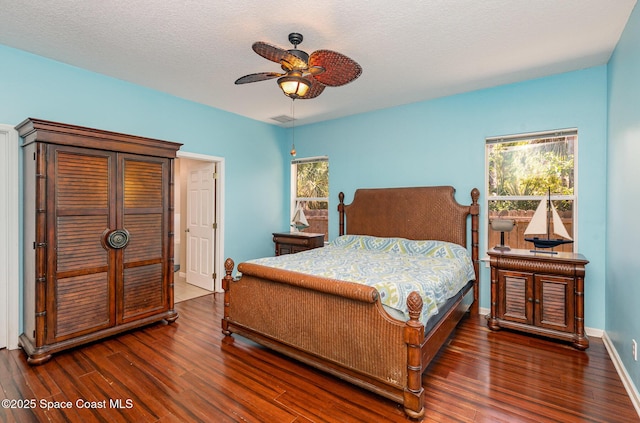 2871 Fontainebleau Ave SE, Palm Bay, FL 32909 - bedroom featuring wood finished floors, a textured ceiling, a ceiling fan, and baseboards