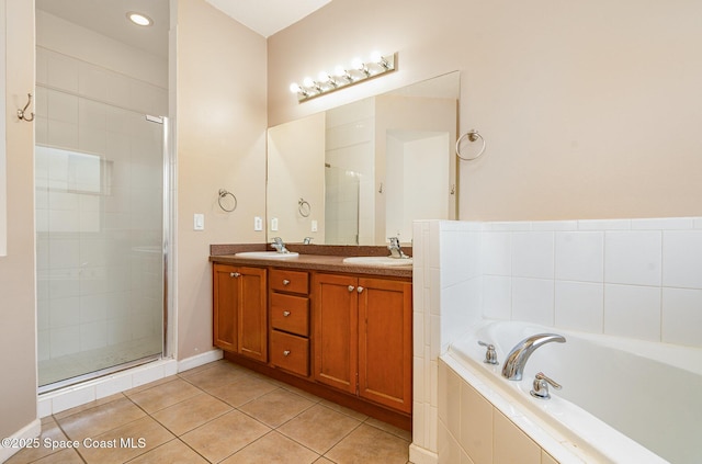 2871 Fontainebleau Ave SE, Palm Bay, FL 32909 - bathroom with a garden tub, tile patterned floors, double vanity, and a stall shower