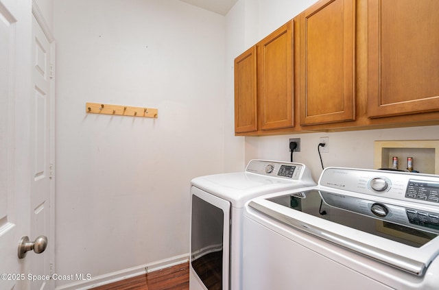 2871 Fontainebleau Ave SE, Palm Bay, FL 32909 - laundry room with washer and clothes dryer, cabinet space, dark wood finished floors, and baseboards