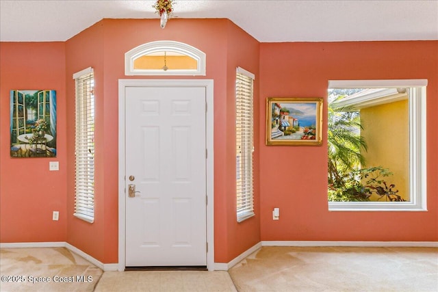 1550 Holcomb St NW, Street, Palm Bay, FL 32907 - foyer with light carpet, baseboards, plenty of natural light, and vaulted ceiling