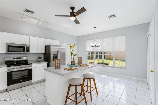 2508 Coral Ridge Cir, Melbourne, FL 32935 - kitchen with appliances with stainless steel finishes, a ceiling fan, light tile patterned flooring, and light countertops
