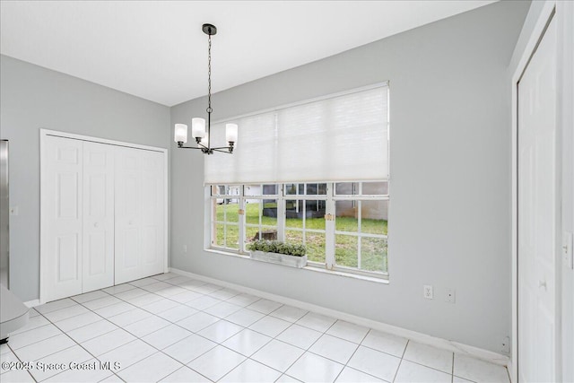2508 Coral Ridge Cir, Melbourne, FL 32935 - unfurnished dining area featuring a chandelier, baseboards, and light tile patterned floors